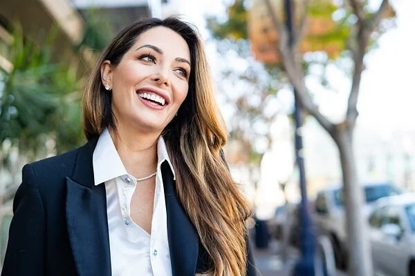Woman smiling while walking outdoors