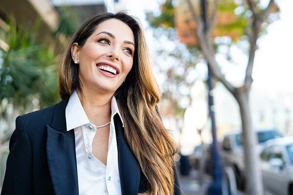 Woman smiling while walking outdoors