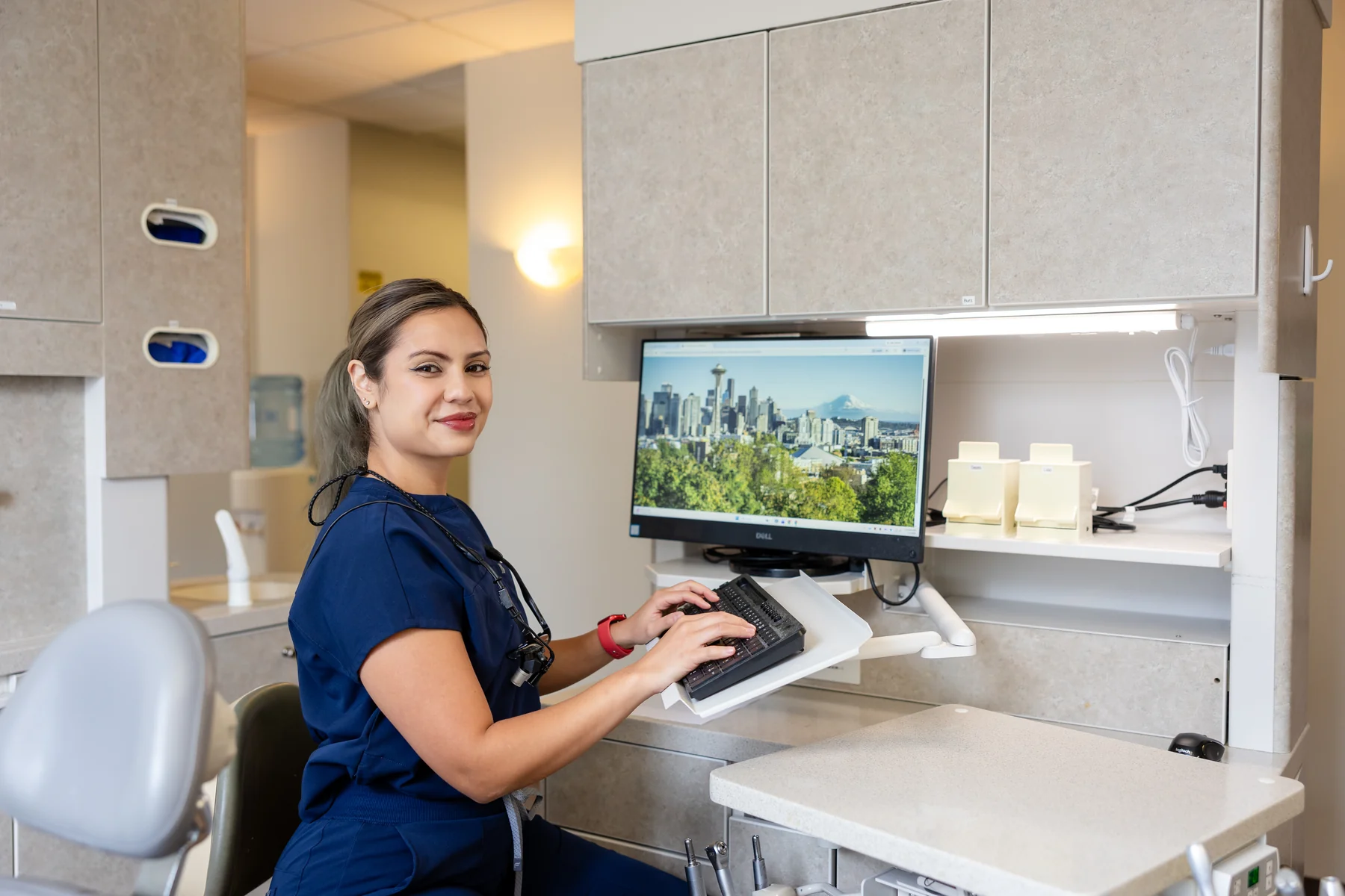 Team member scheduling at the front computer in a Downtown Seattle Dentists treatment room