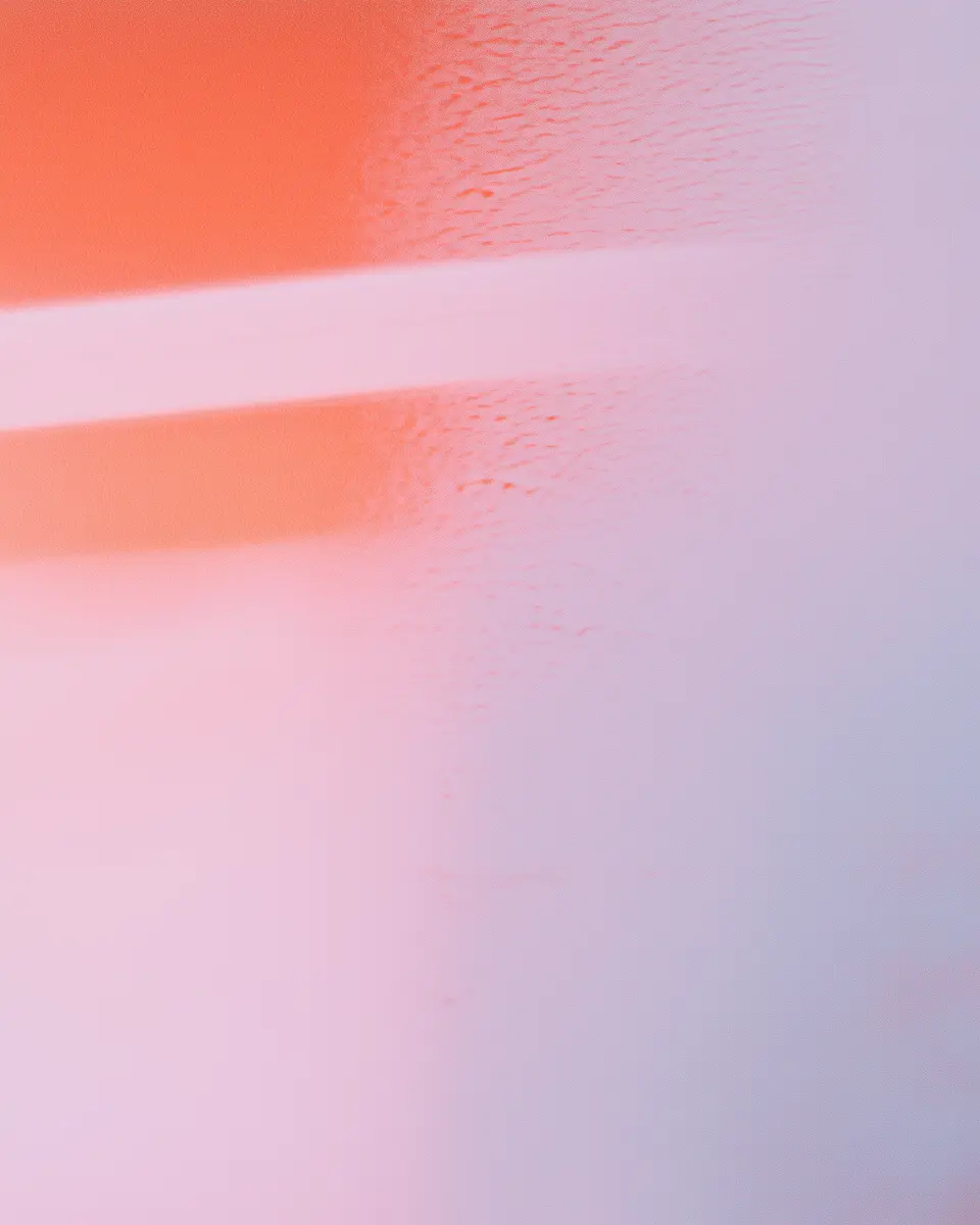 Abstract soft gradient with pink, orange, and purple hues blending smoothly.