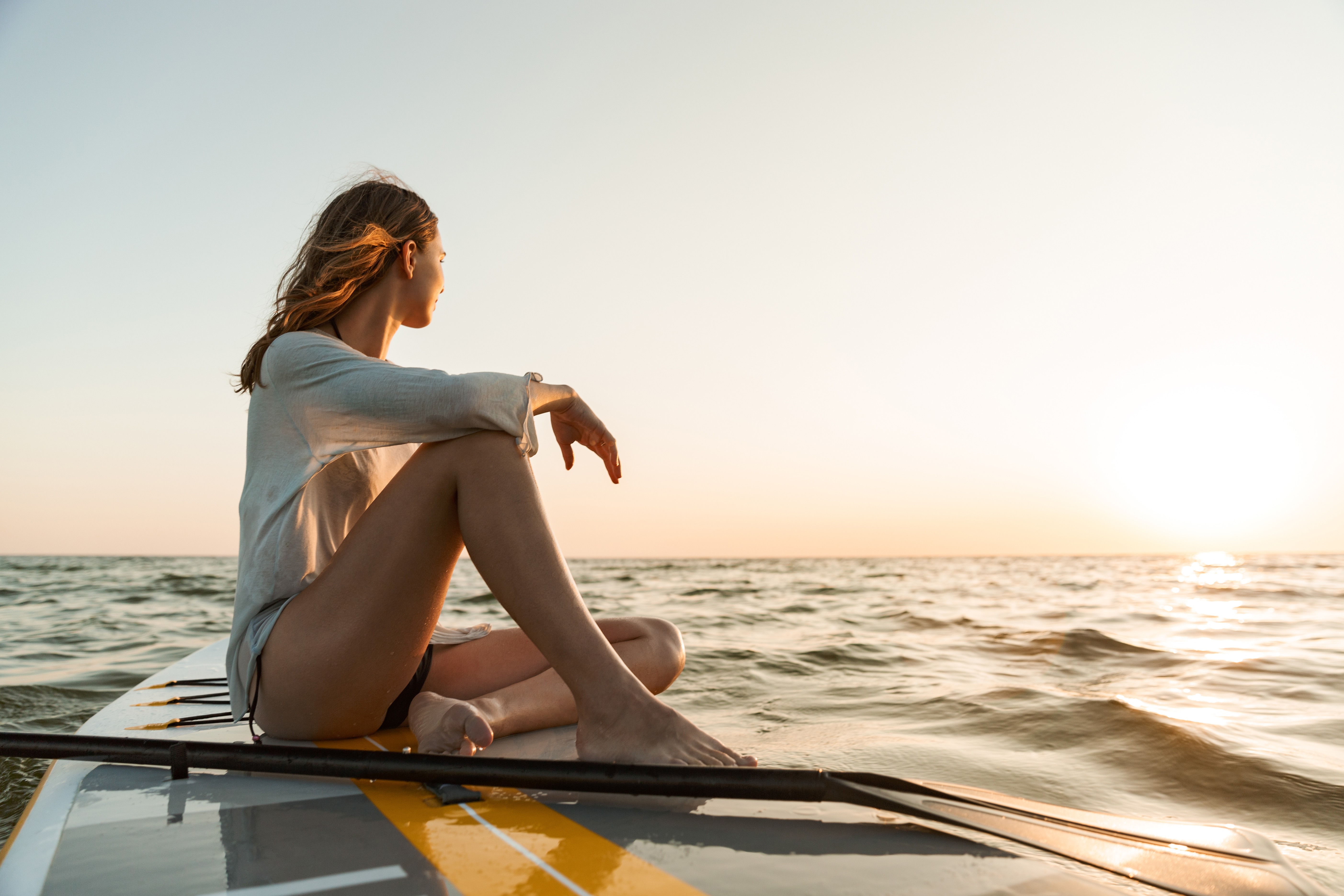Woman on paddleboard stock image