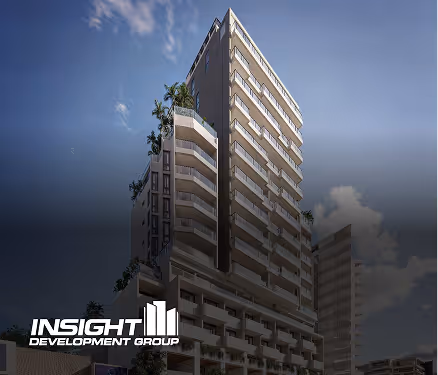 Modern high-rise building at dusk with Insight Development Group logo in the corner.