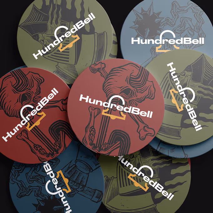 Round coasters with skeleton and knight helmet designs branded with HundredBell logo in various colors. (mockupnest.com)