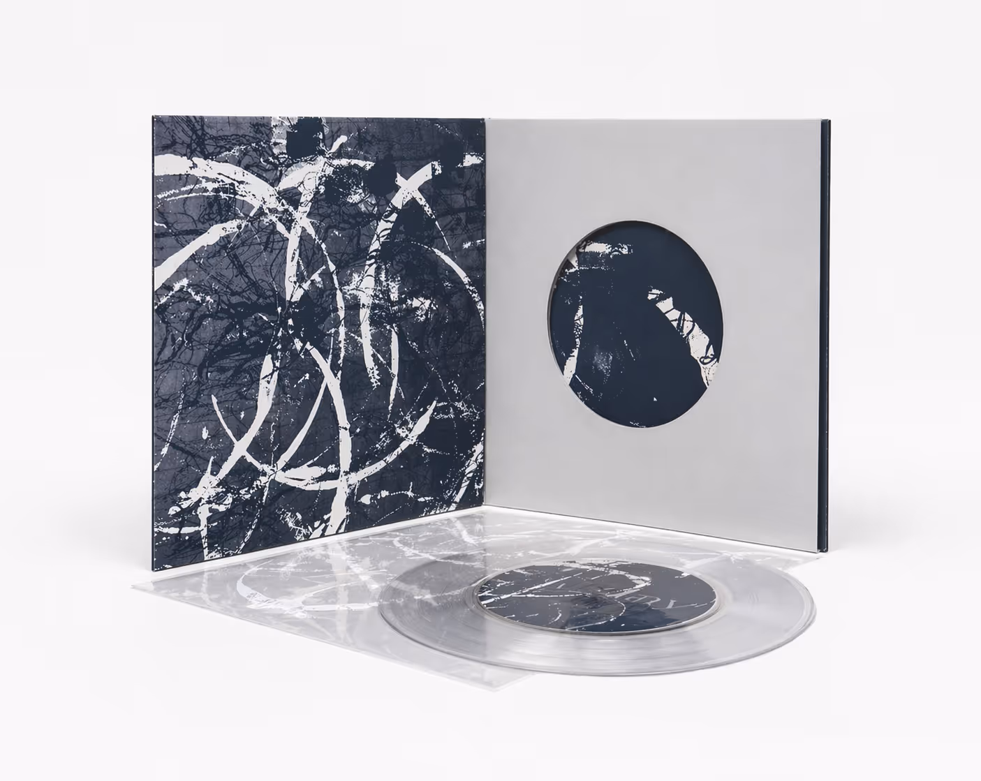 Clear vinyl record with black and white abstract splatter art on cover and inner sleeve.