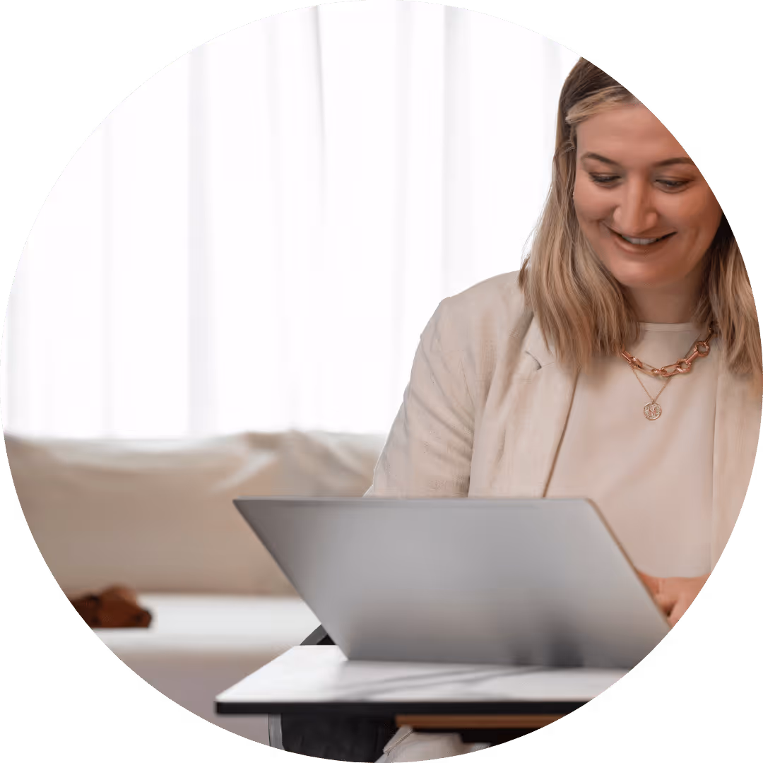 Happy lady using her laptop at a hotel