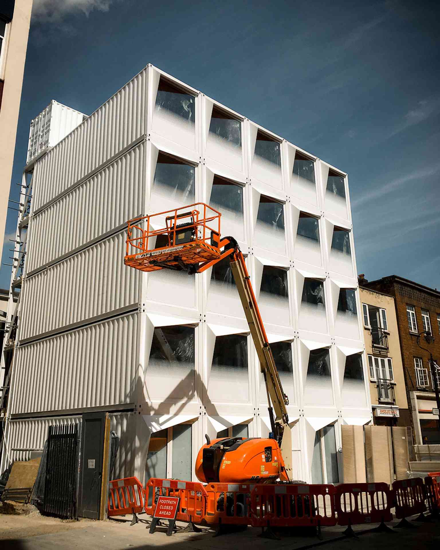 Shipping containers being assembled during Stow Away Waterloo's construction