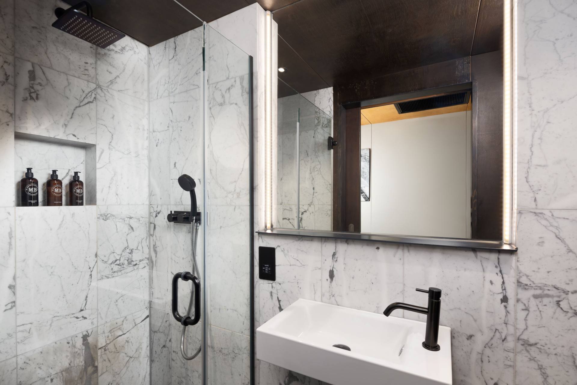 Marble-tiled bathroom in a Stow Away Waterloo studio apartment