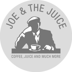 Joe & The Juice logo with a silhouette of a man drinking coffee and a cup on the table.