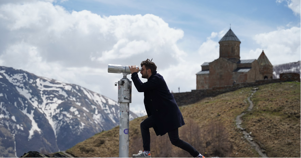 Image source: https://unsplash.com/photos/a-man-taking-a-picture-of-a-castle-on-a-mountain-rmQpfygaFto