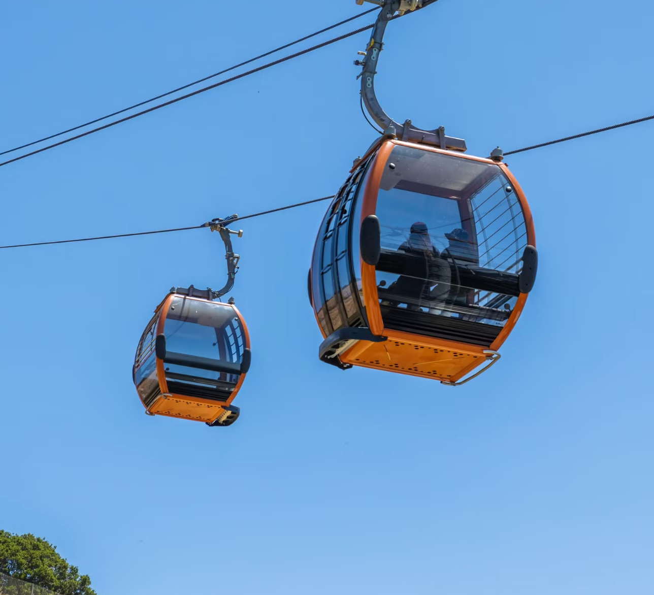 Cable car ascending a green mountain above Puerto Plata.