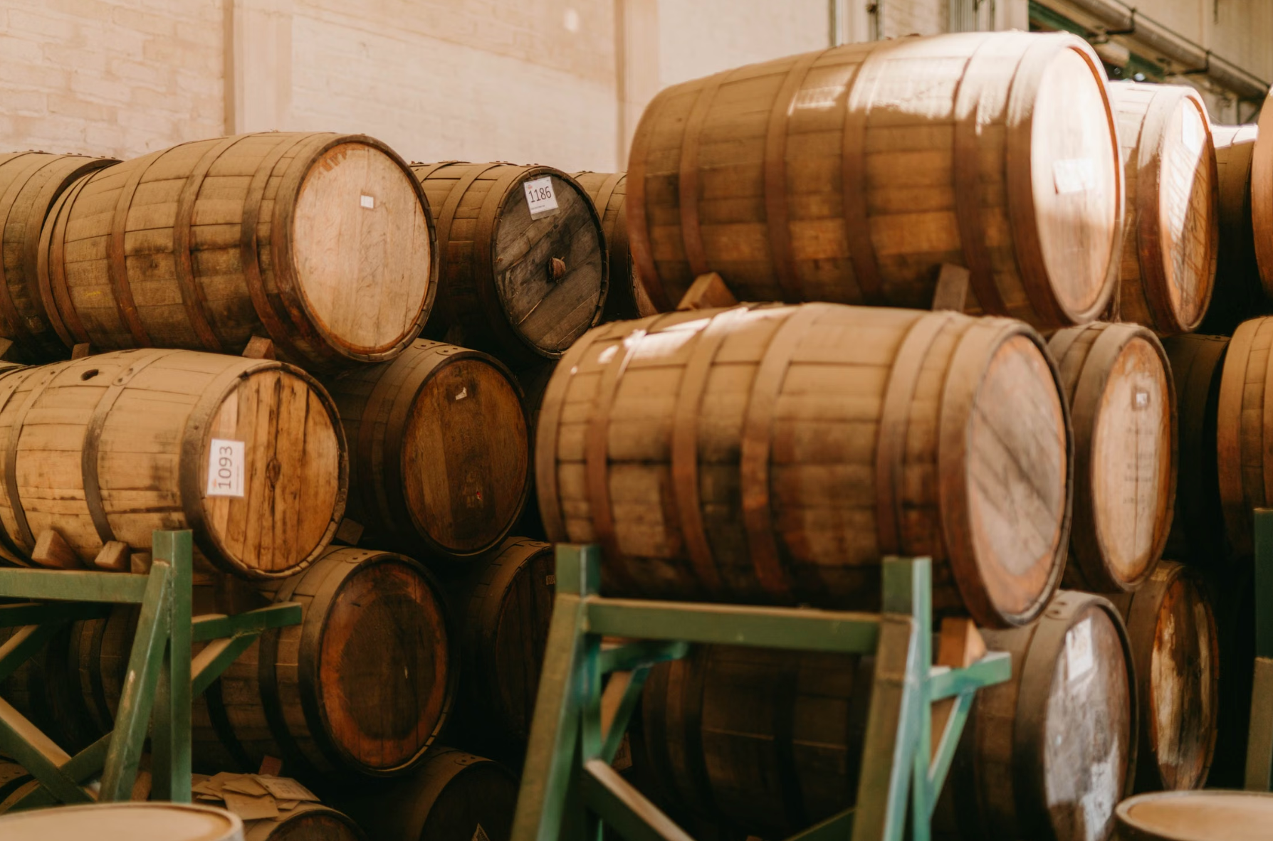 Dark rum barrels ageing inside a Dominican distillery warehouse.