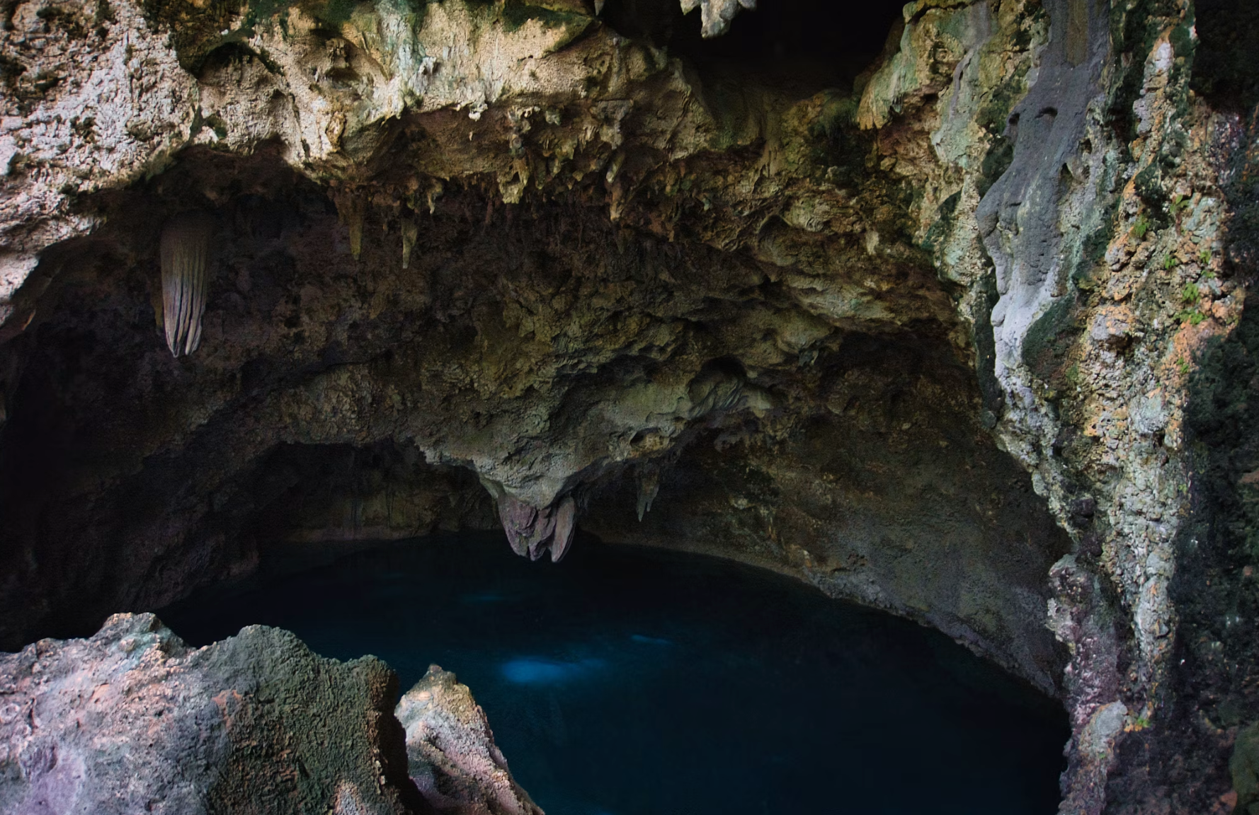 Blue freshwater lake inside a limestone cave system.