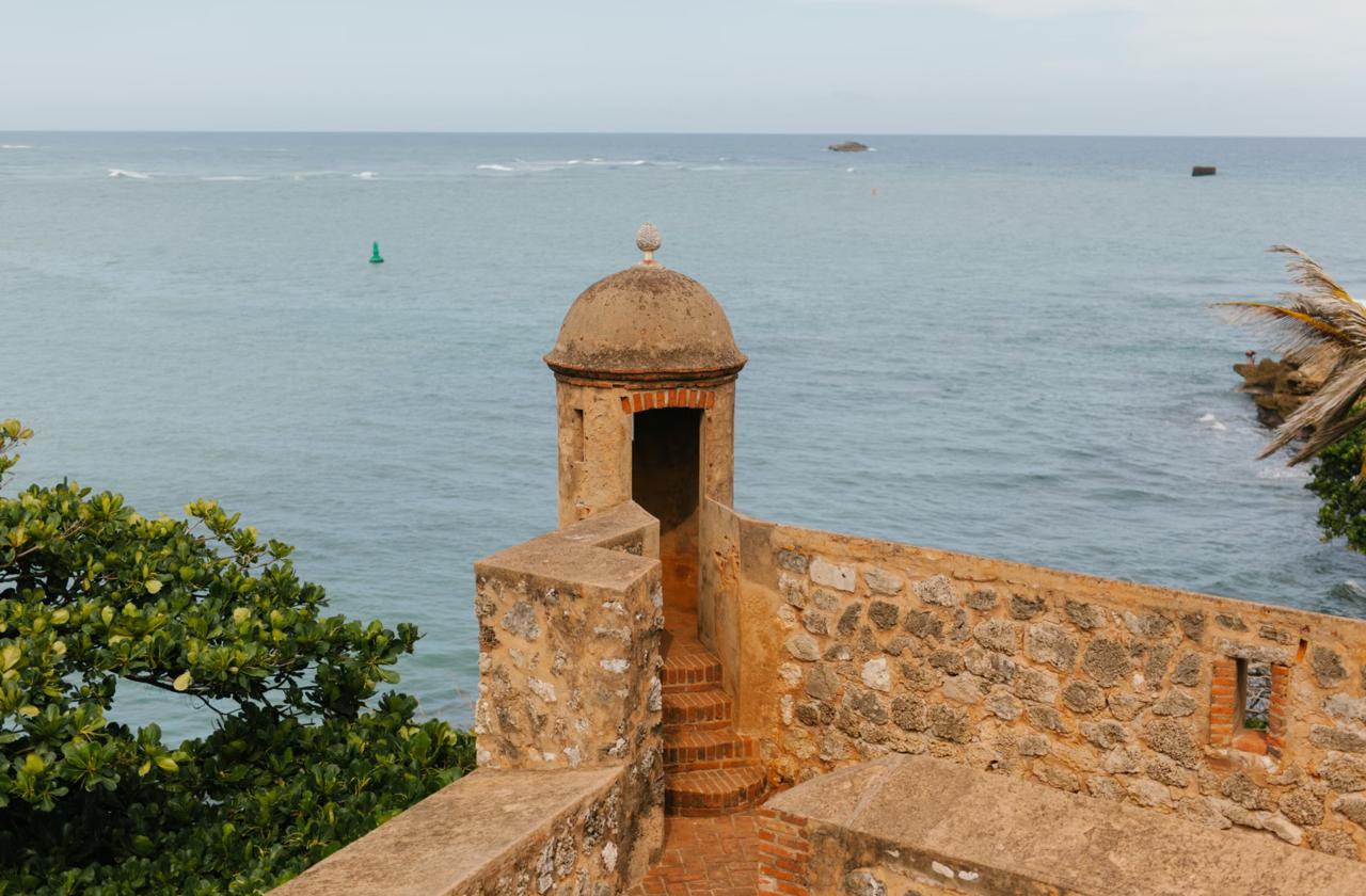 A stone sentry tower on the walls of Fortaleza San Felipe overlooking the Atlantic Ocean in Puerto Plata Dominican Republic