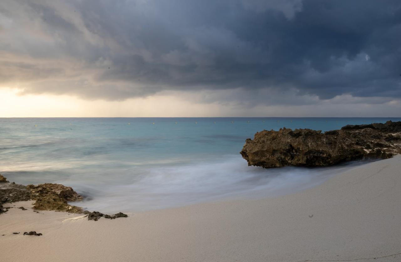 Grey storm clouds building over a Caribbean coastline during Dominican Republic hurricane season from June to November