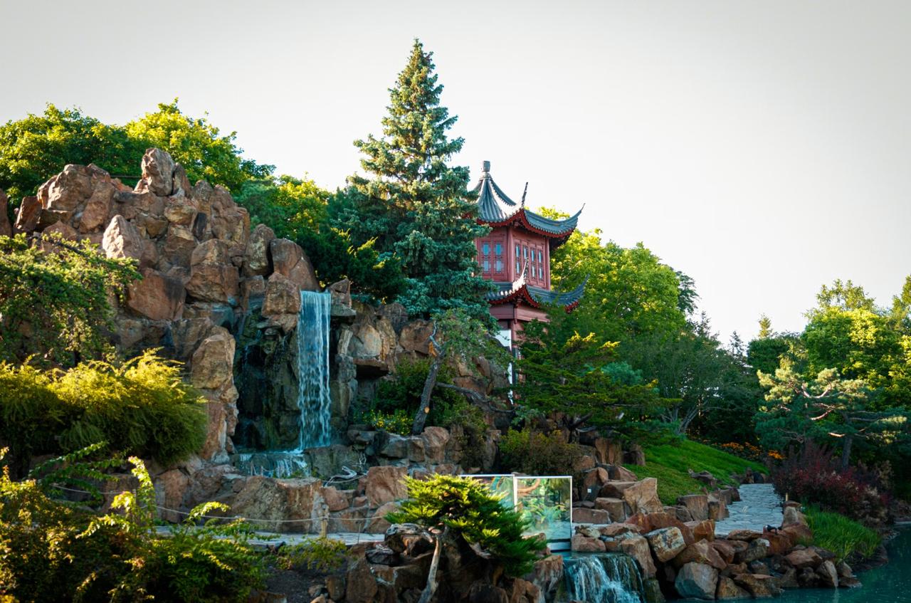 Lush beds and glasshouse at the Montreal Botanical Garden in late summer