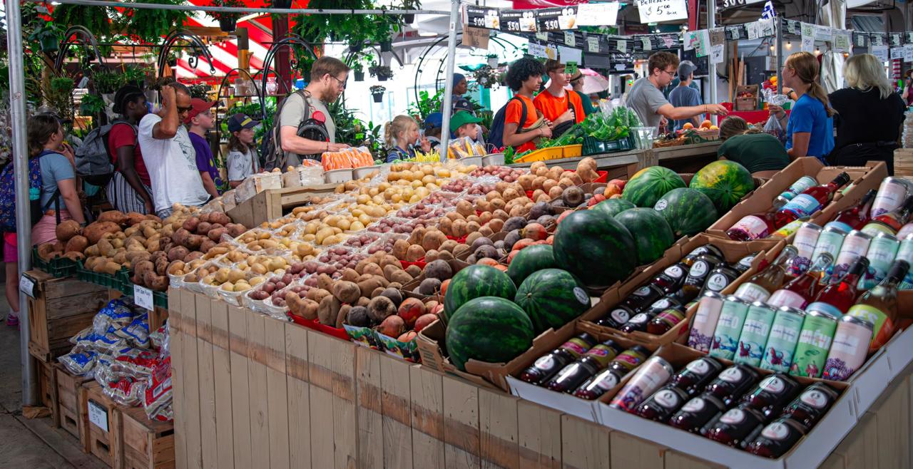 Stalls piled with fresh produce and Quebec products at the covered Jean-Talon Market