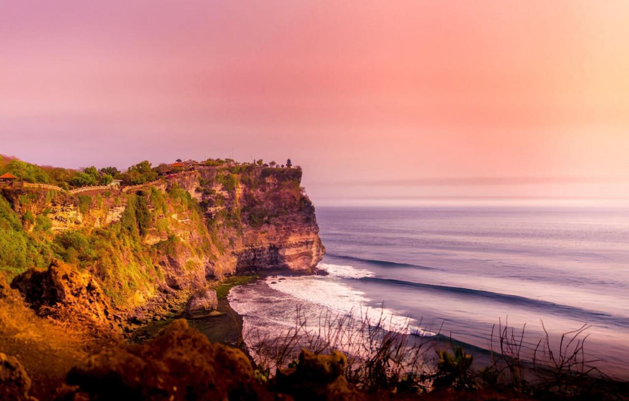 The famous Uluwatu temple at sunset on the edge of a high cliff overlooking the Indian Ocean in Bali, Indonesia