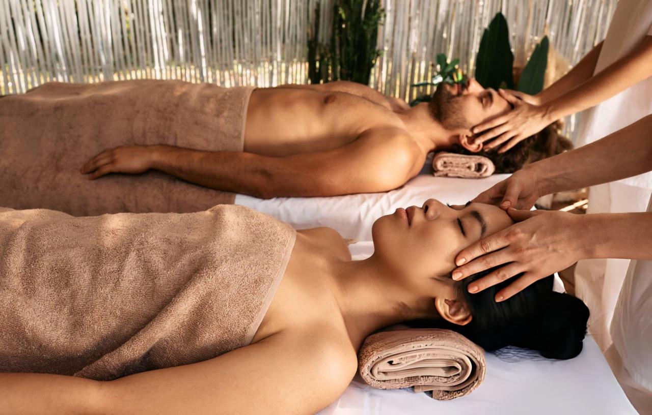 couple getting head massage and enjoys relaxing at spa