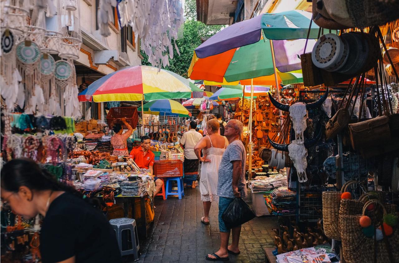 Colorful vendor stalls at Samadi Sunday Market in Canggu Bali with crowds