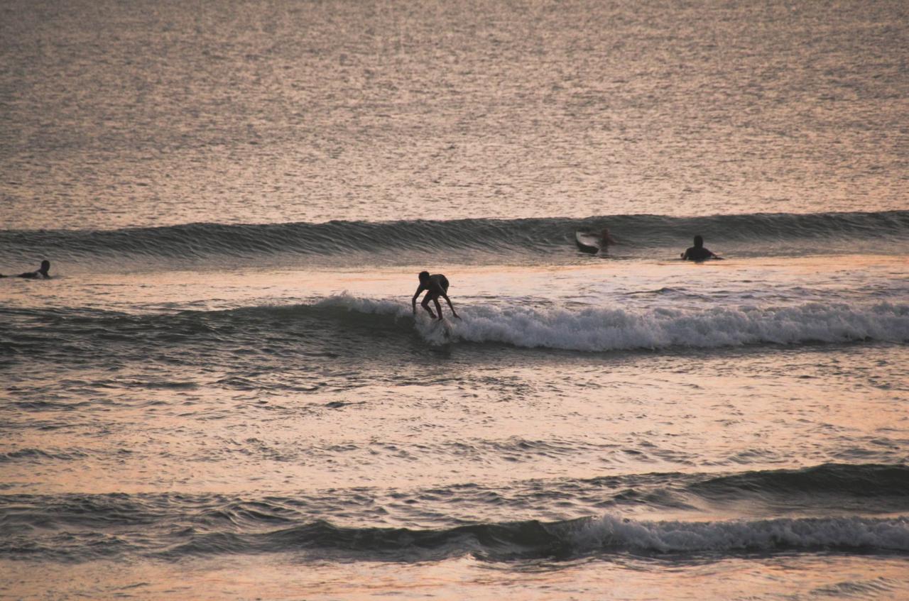 Beginner surfers learning to surf at Batu Bolong Beach in Canggu Bali