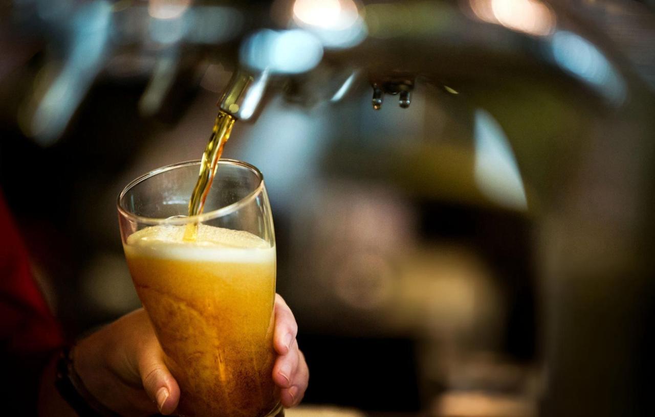 fresh draft beer pouring into a glass