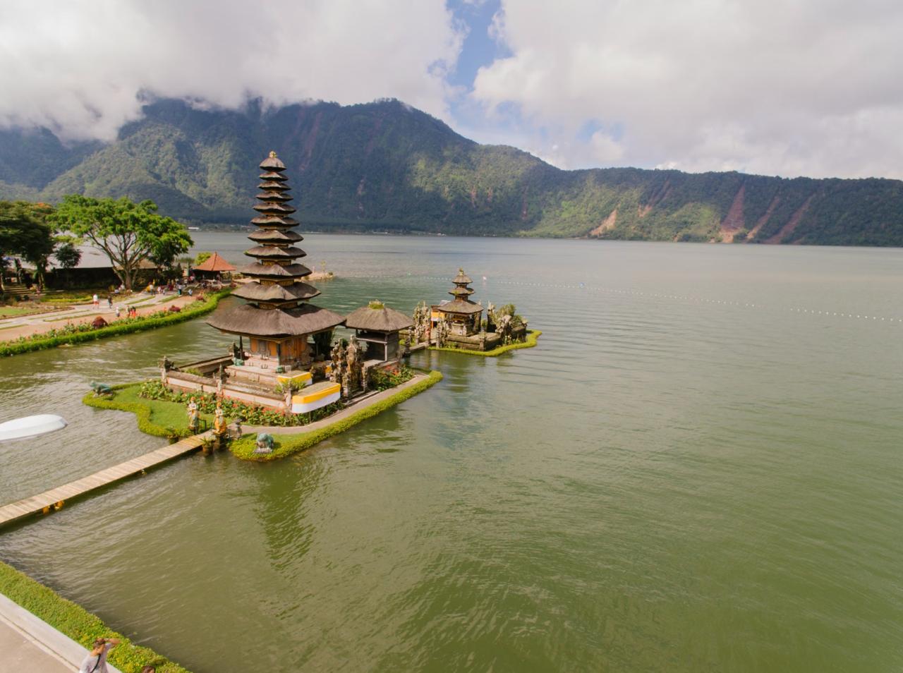 Hindu temple at mountain peak overlooking vast island landscape
