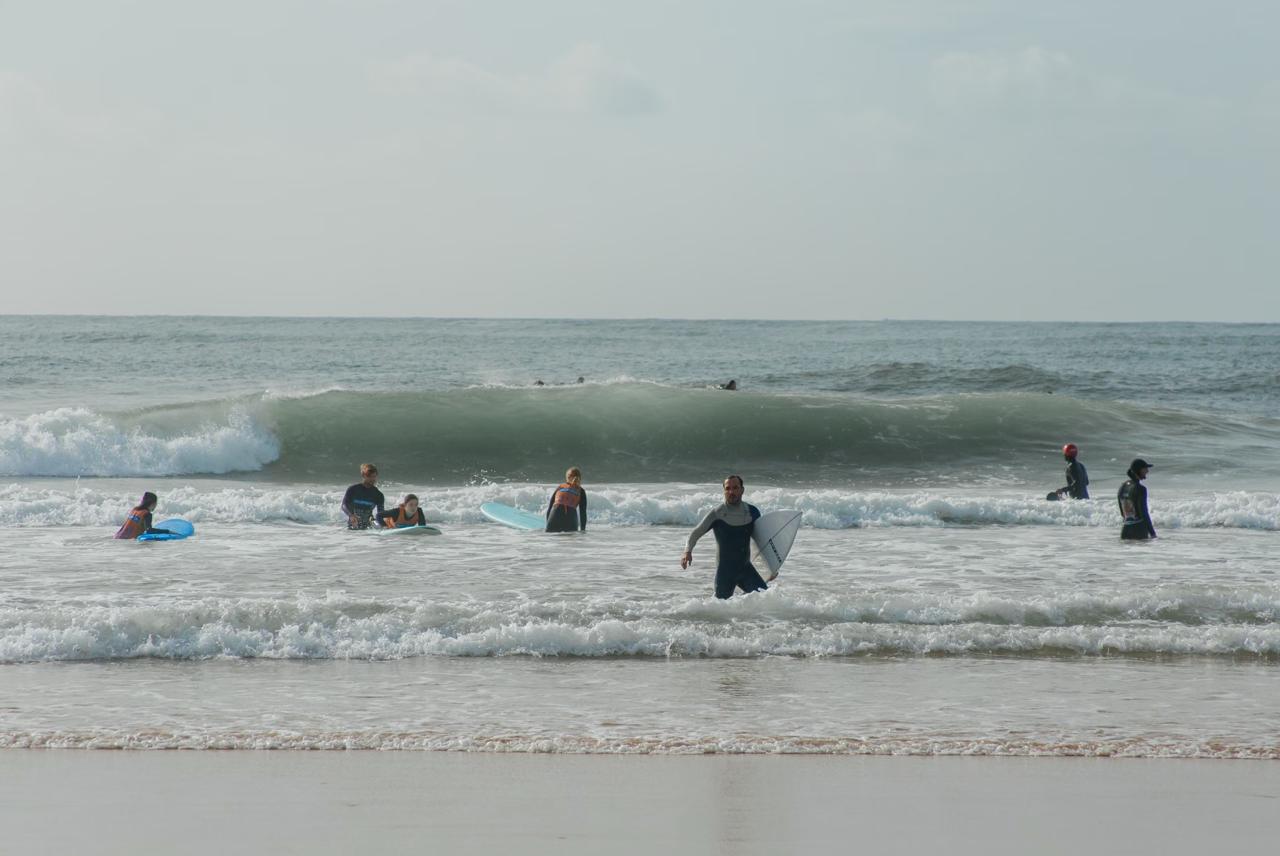 Surfing lesson at Seminyak Beach with instructor and beginner on board