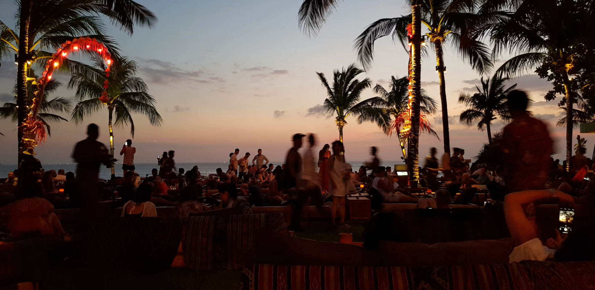 Petitenget Beach with evening crowds and sunset view