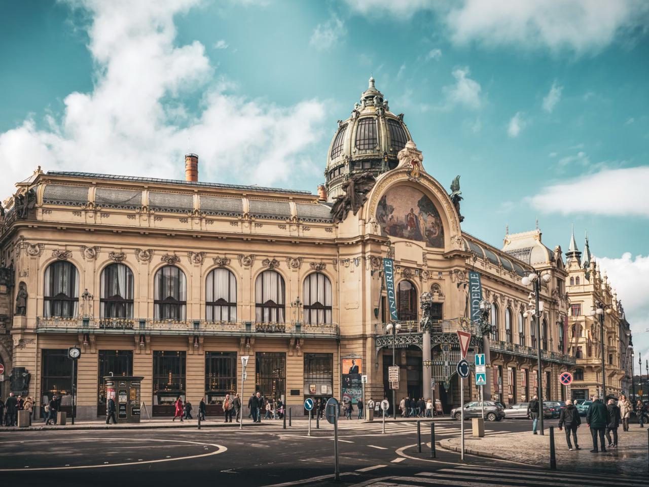 Pedestrians strolling past the ornate domed CEC Palace on Calea Victoriei boulevard