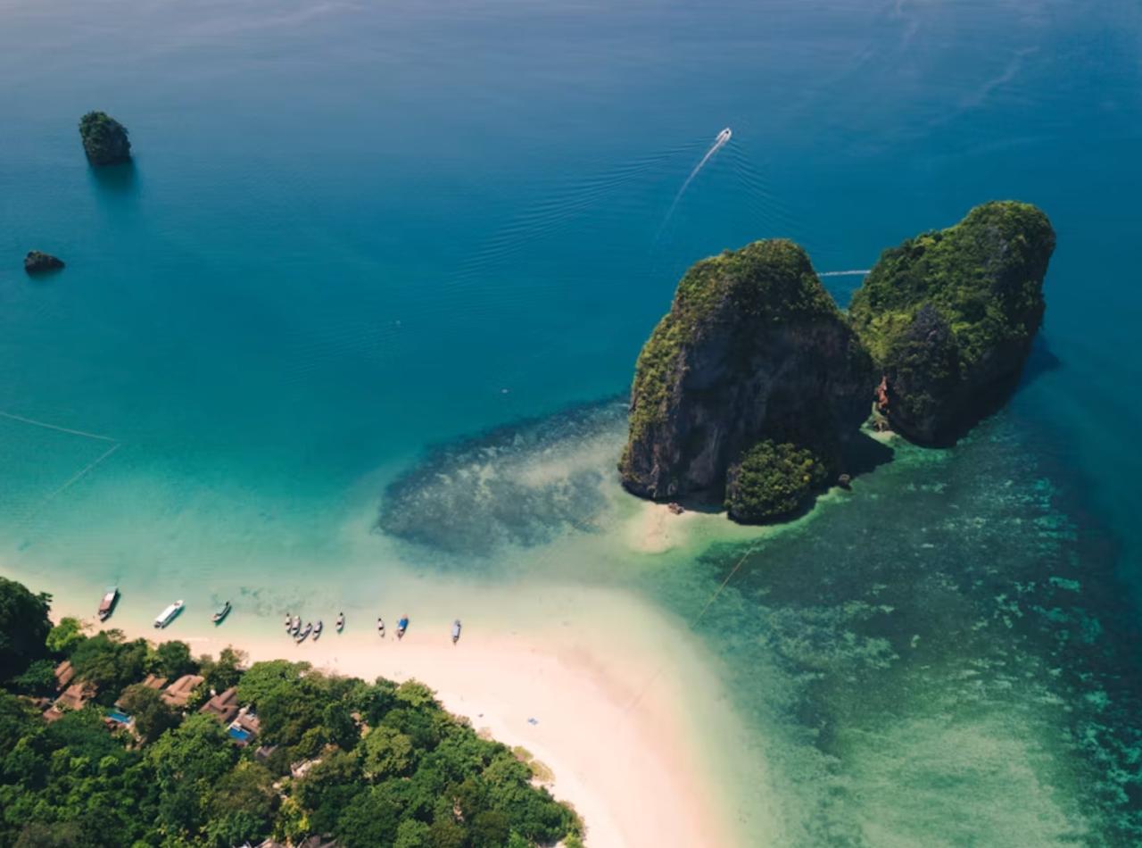 Krabi limestone cliffs rising above emerald tropical waters.