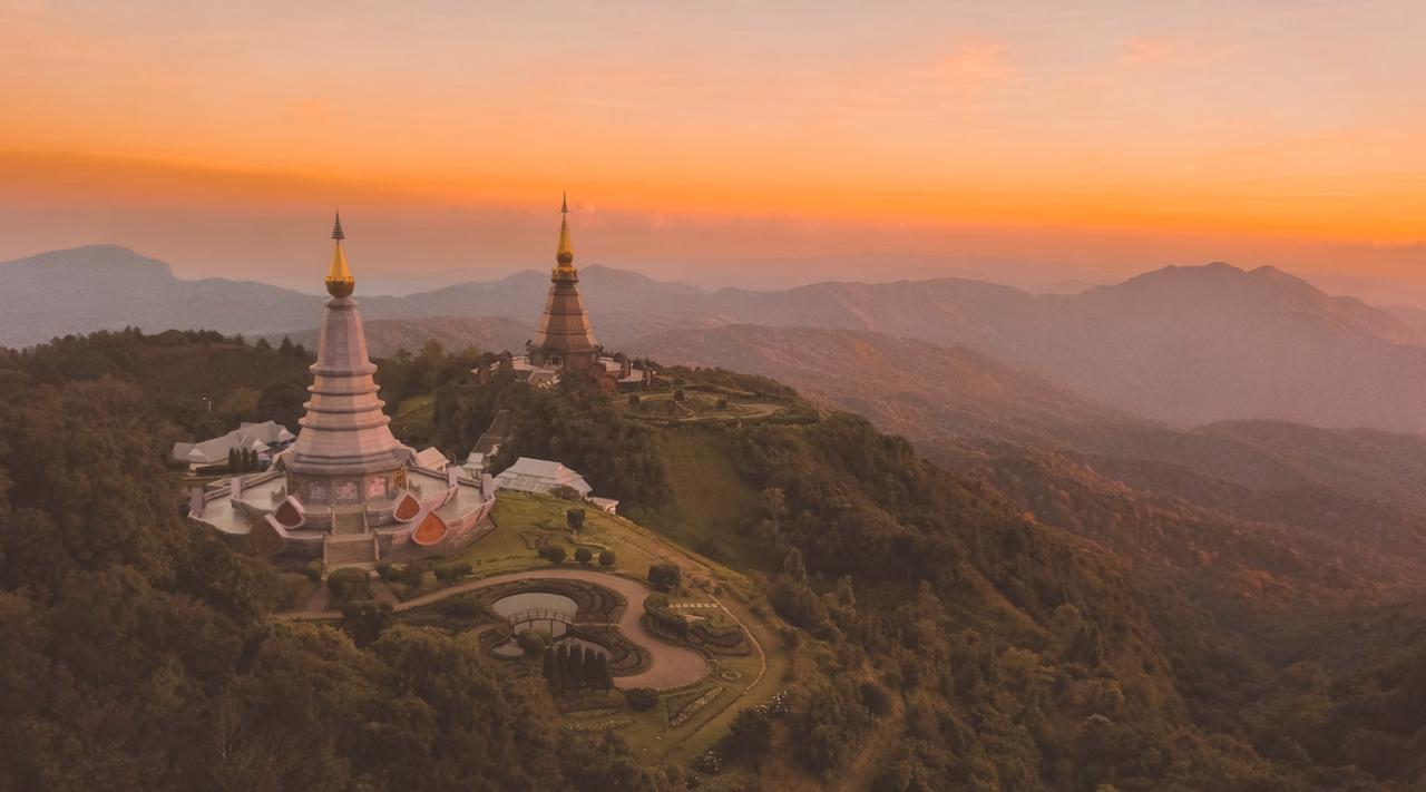 Rolling mountains surrounding the peaceful Pai countryside at sunrise."