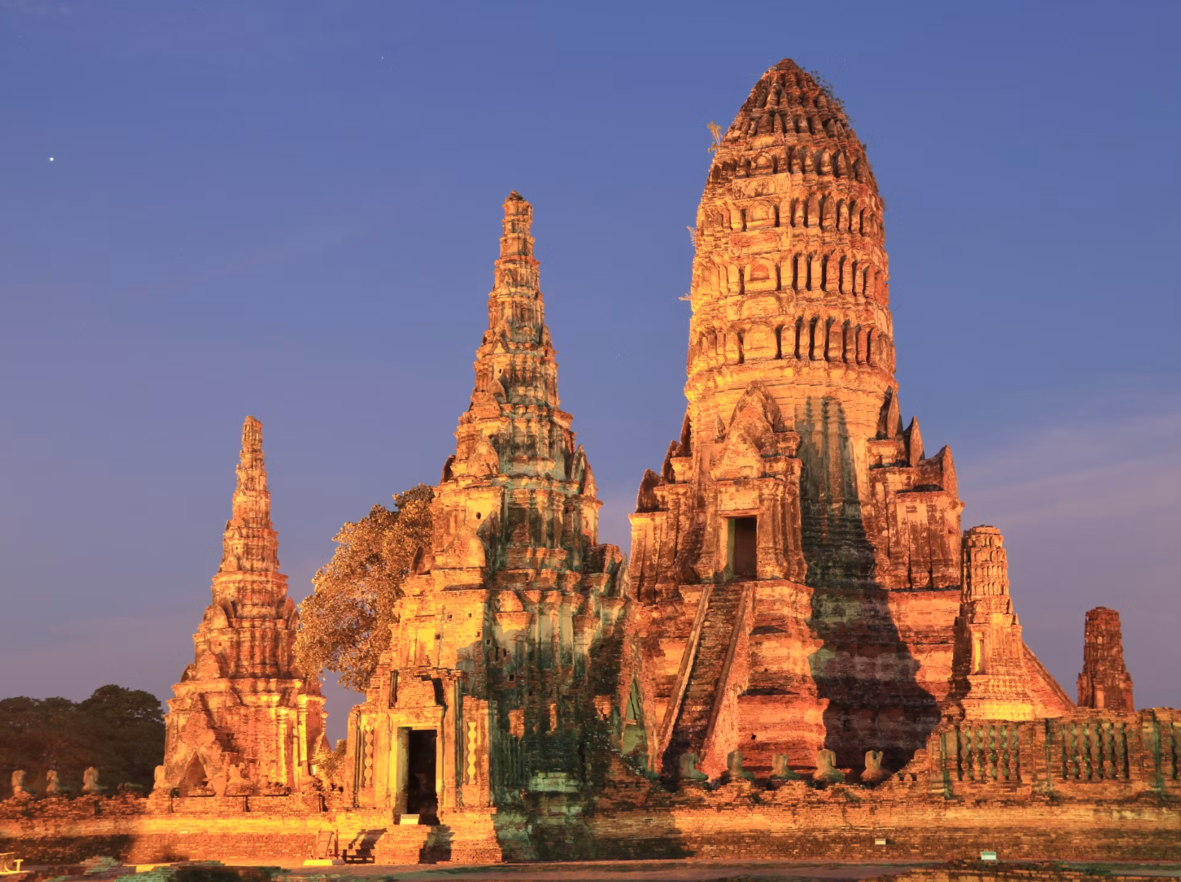 Ancient Ayutthaya temple ruins beneath a bright blue sky.