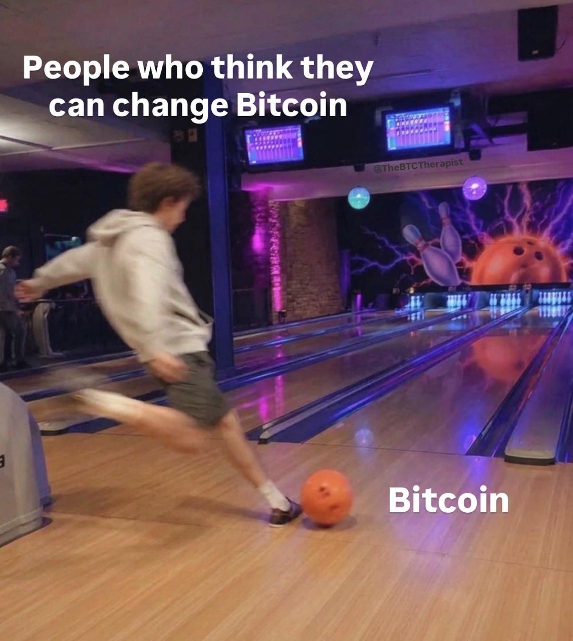 Man attempting to kick bowling ball, labelled Bitcoin.