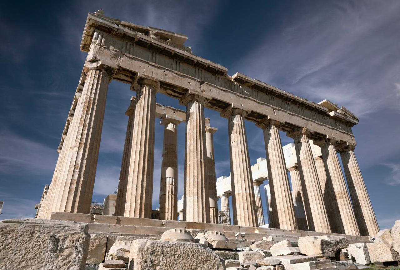 Parthenon's weathered Doric marble columns against a cloudless blue Greek sky.