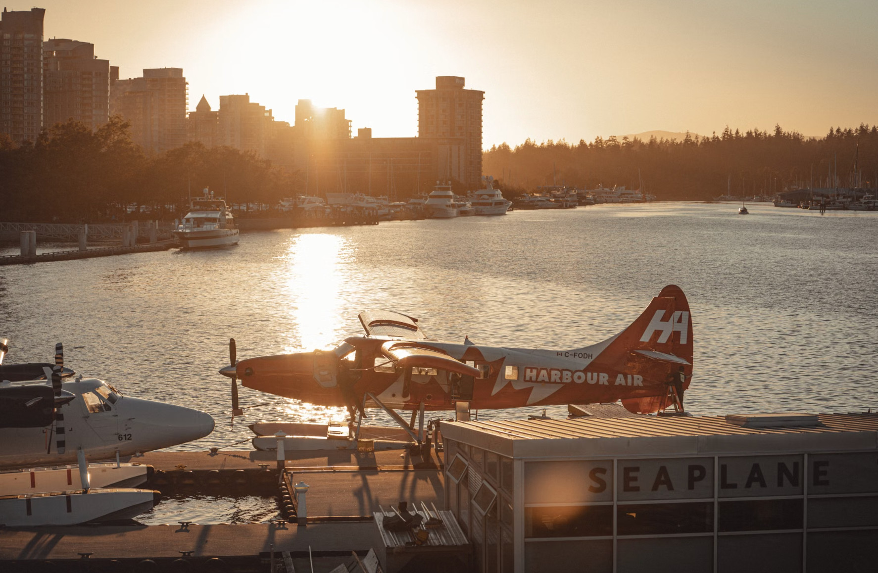 Harbour Air seaplane docked at Vancouver seaplane terminal at sunset