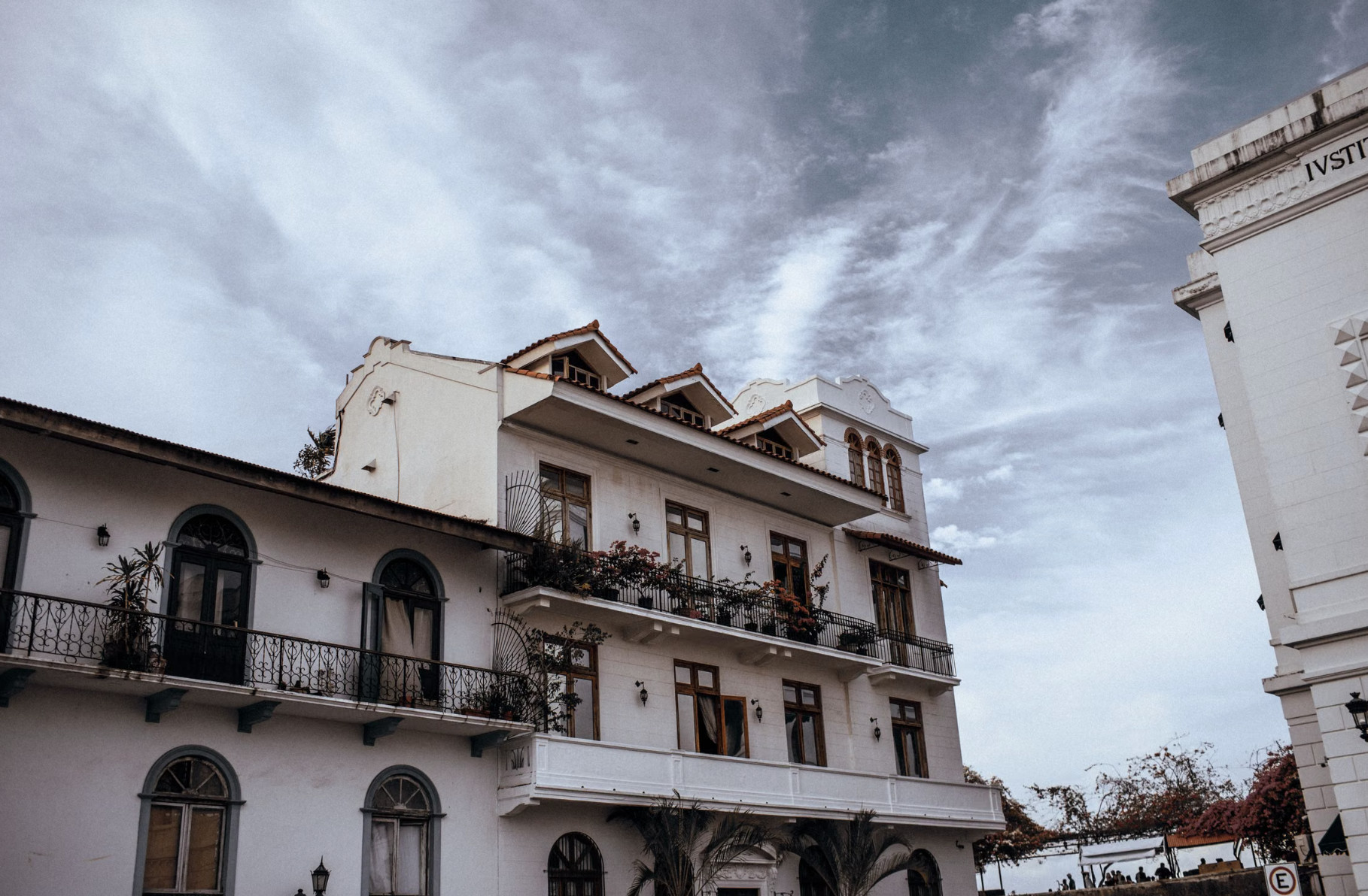 White colonial buildings with balconies under cloudy Casco Viejo sky