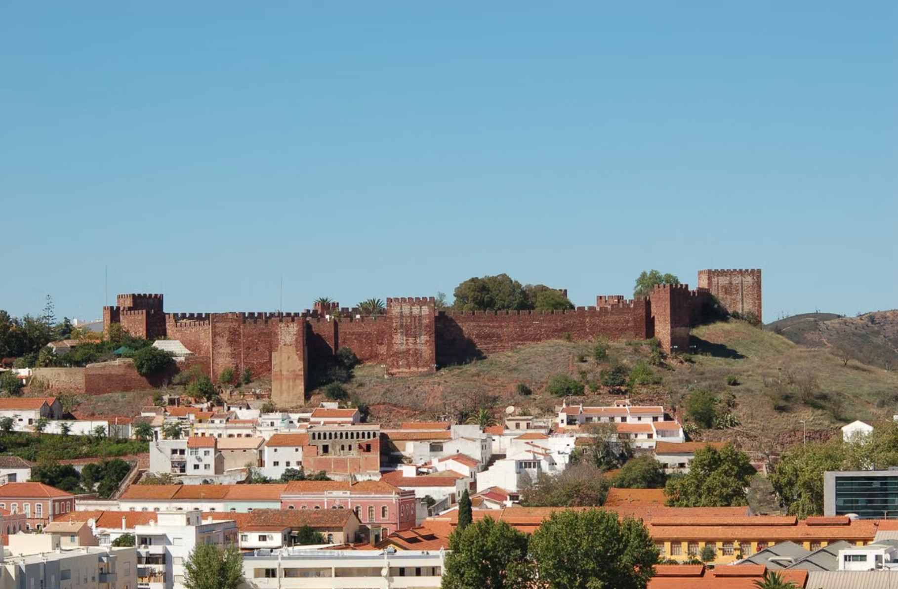 Red sandstone Silves Castle above whitewashed town in inland Algarve