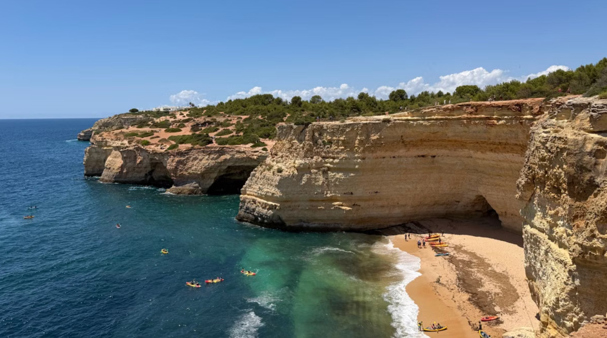 Kayakers and beach beside Benagil sea caves in the Algarve