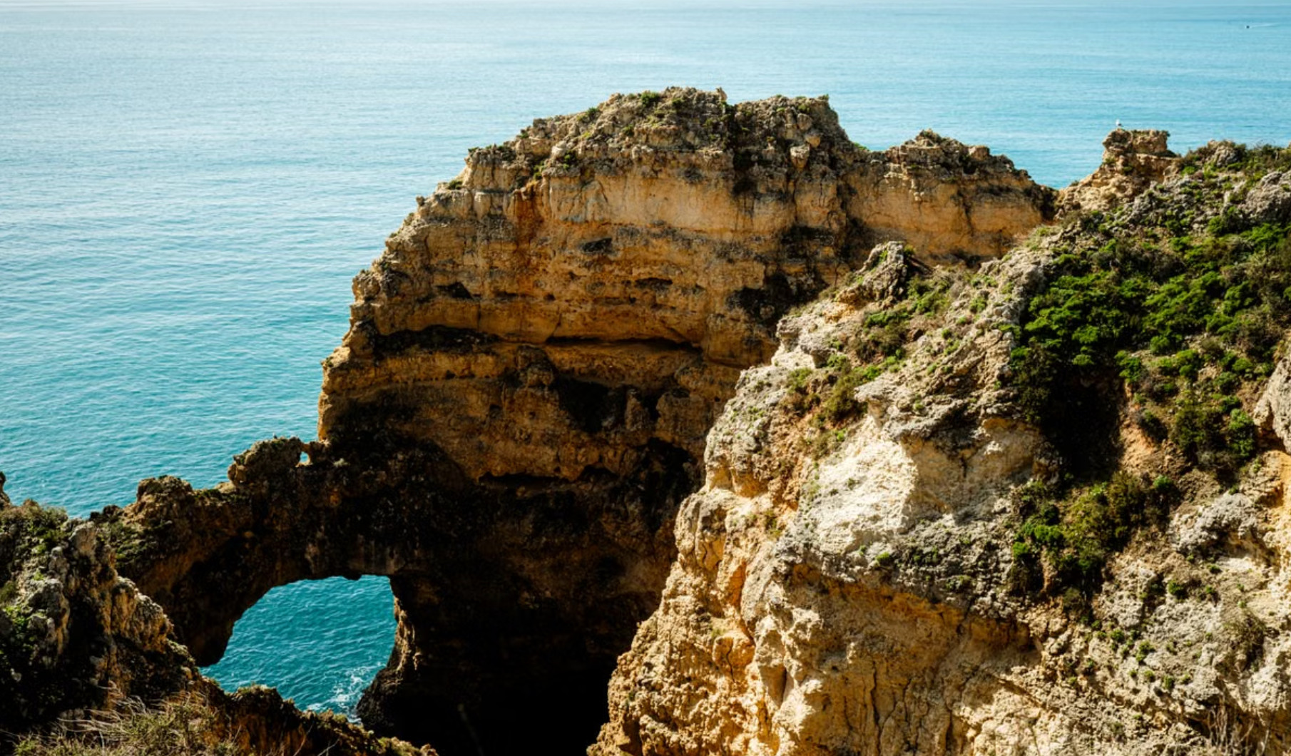 Golden rock arch and sea stacks at Ponta da Piedade