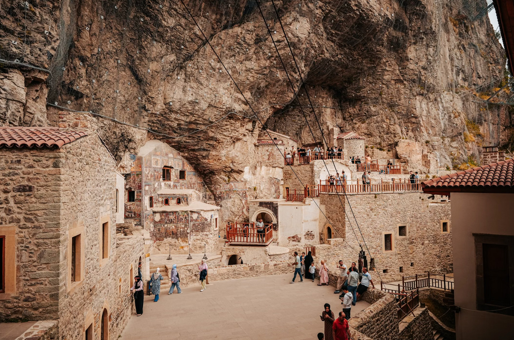 Cliffside cave monastery with frescoes built into rock face