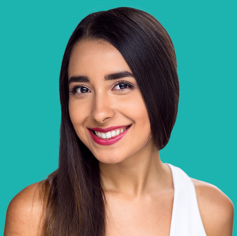 Smiling young woman with long dark hair and pink lipstick against a teal background.