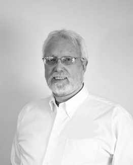 Photo of Dr Nigel Williamson wearing glasses and a white button-up shirt.