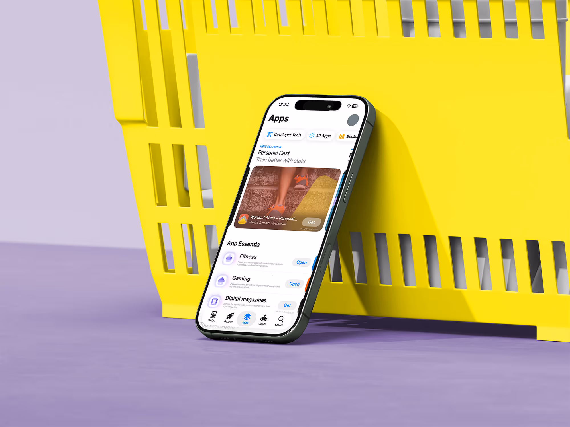 Smartphone showing an app store screen leaning against a yellow crate on a purple surface.