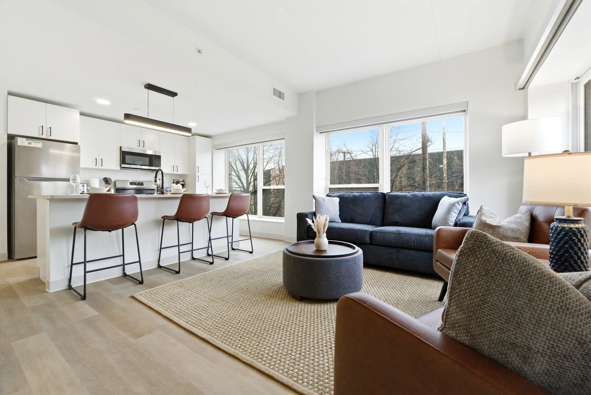Family sharing a meal in the kitchen of a furnished multi-bedroom Nearwell apartment