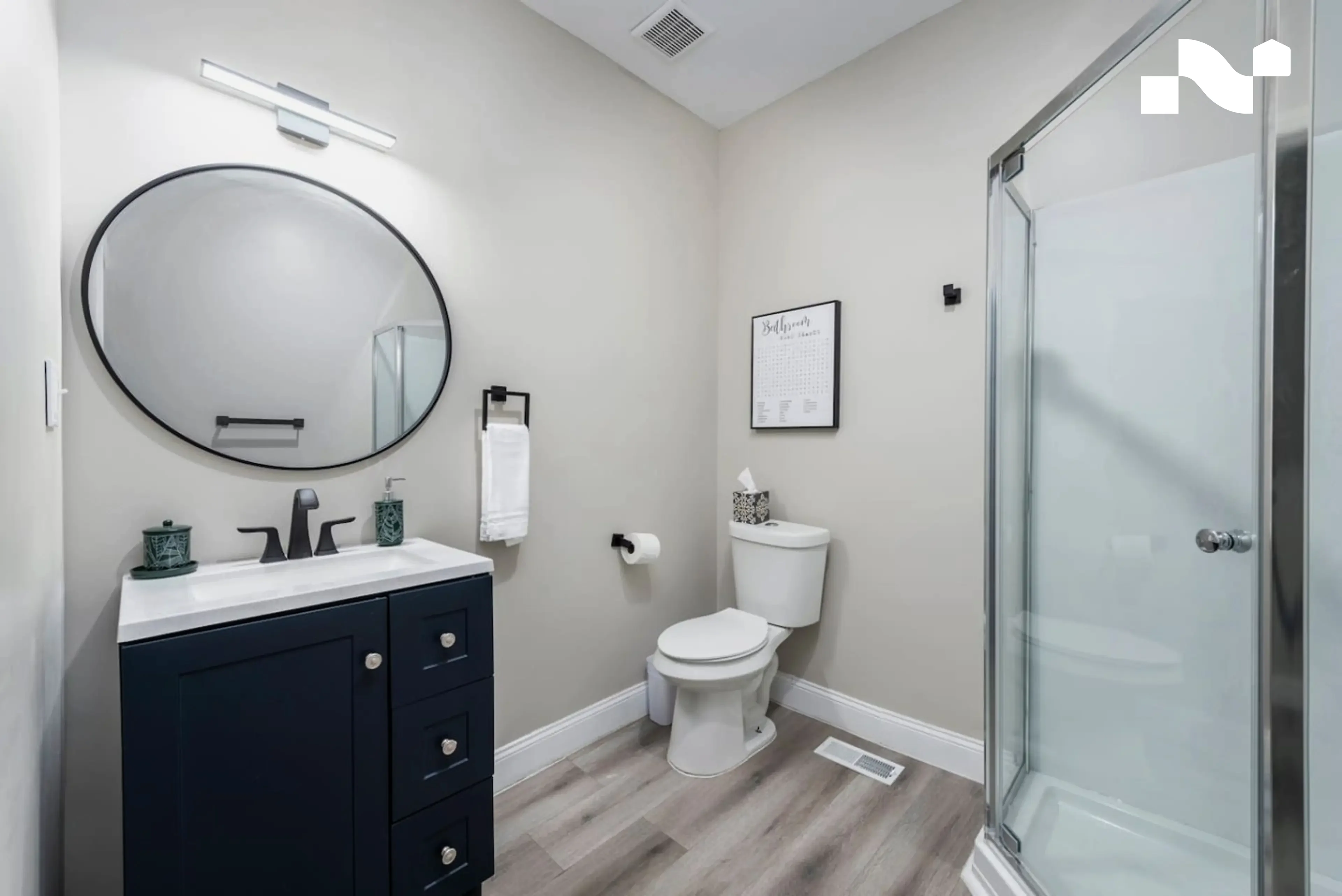 Corner step-in shower with no bathtub in a compact Nearwell apartment bathroom
