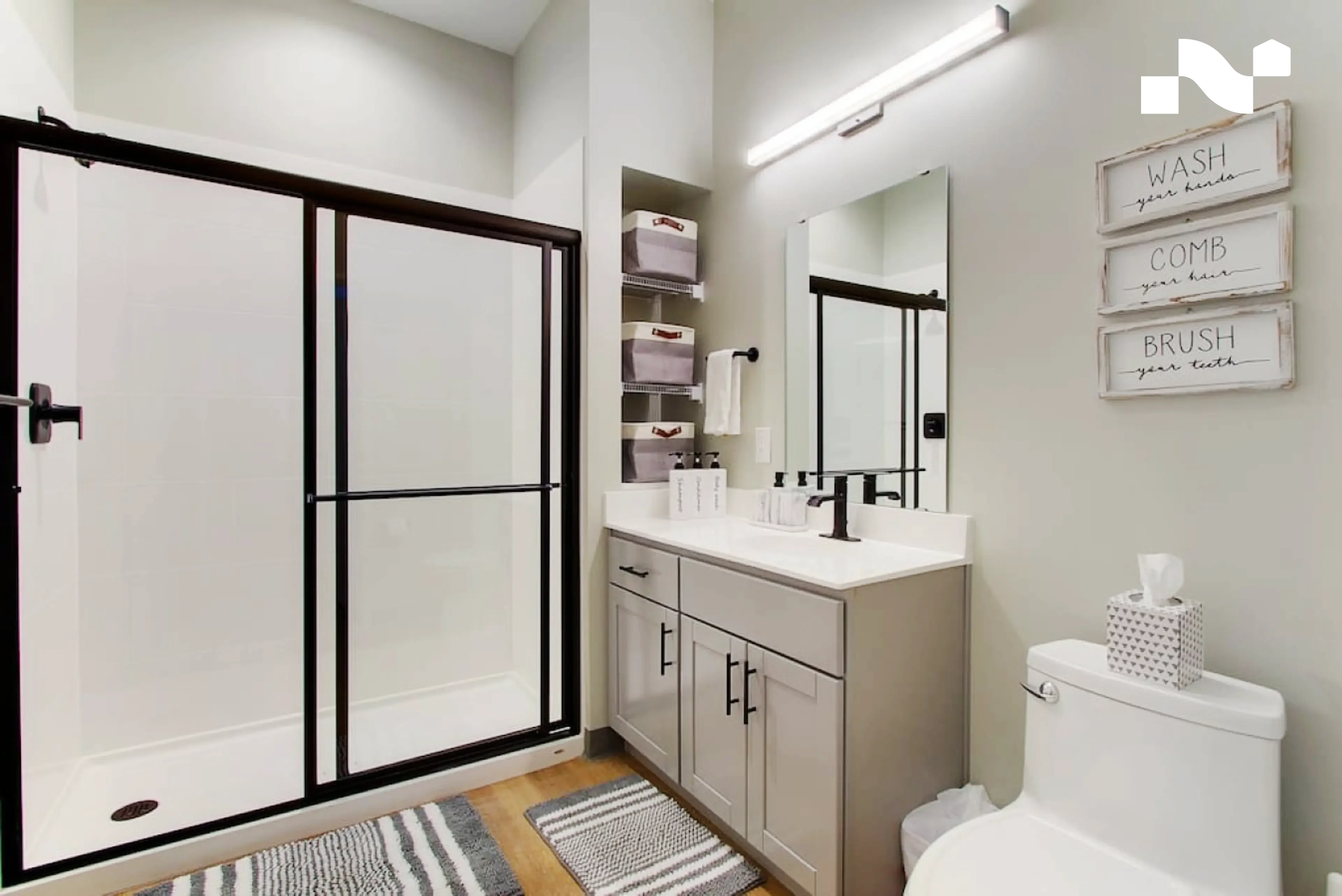 White step-in shower with sliding glass doors and no bathtub in a Nearwell apartment bathroom