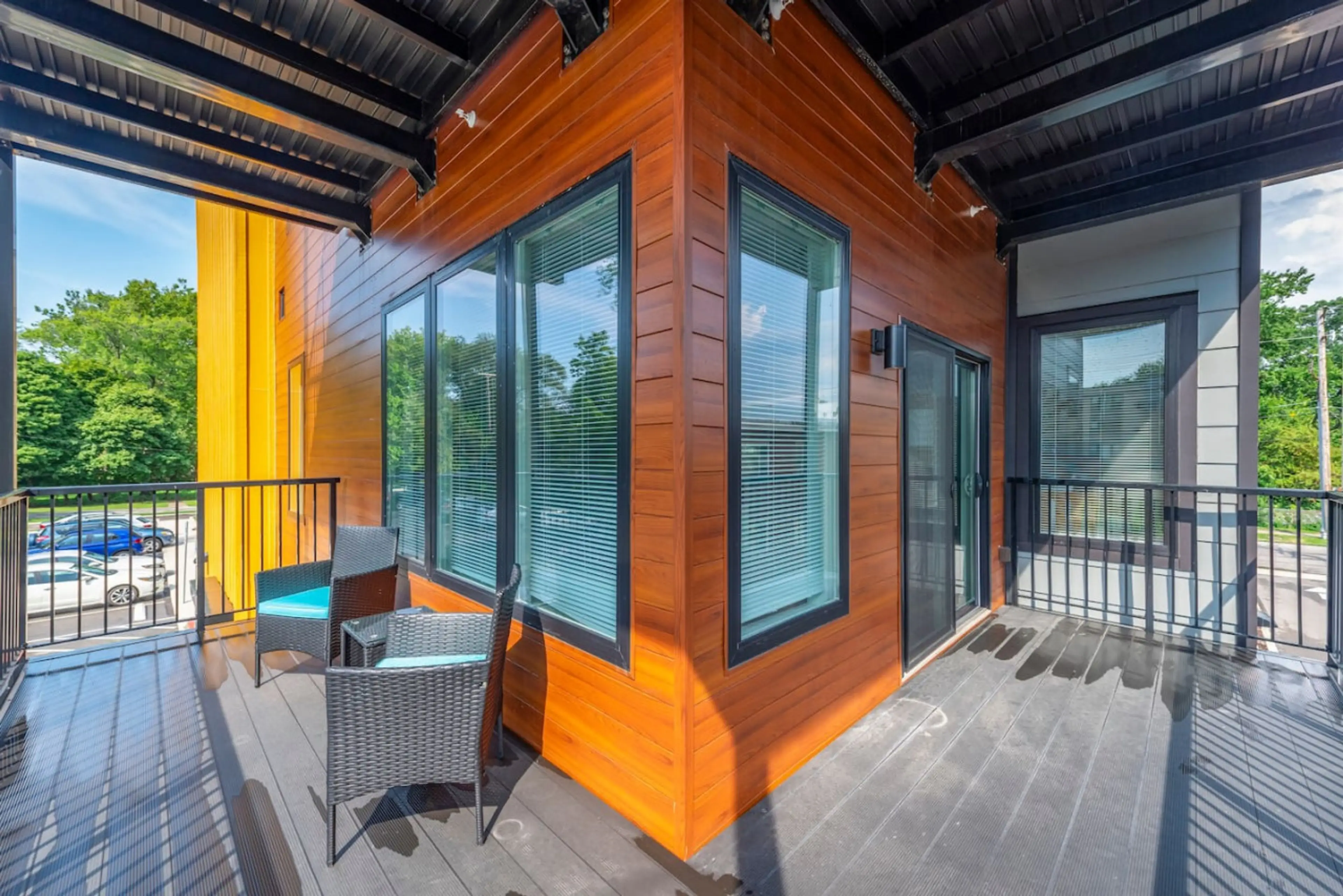 Private balcony with two chairs outside a Nearwell apartment