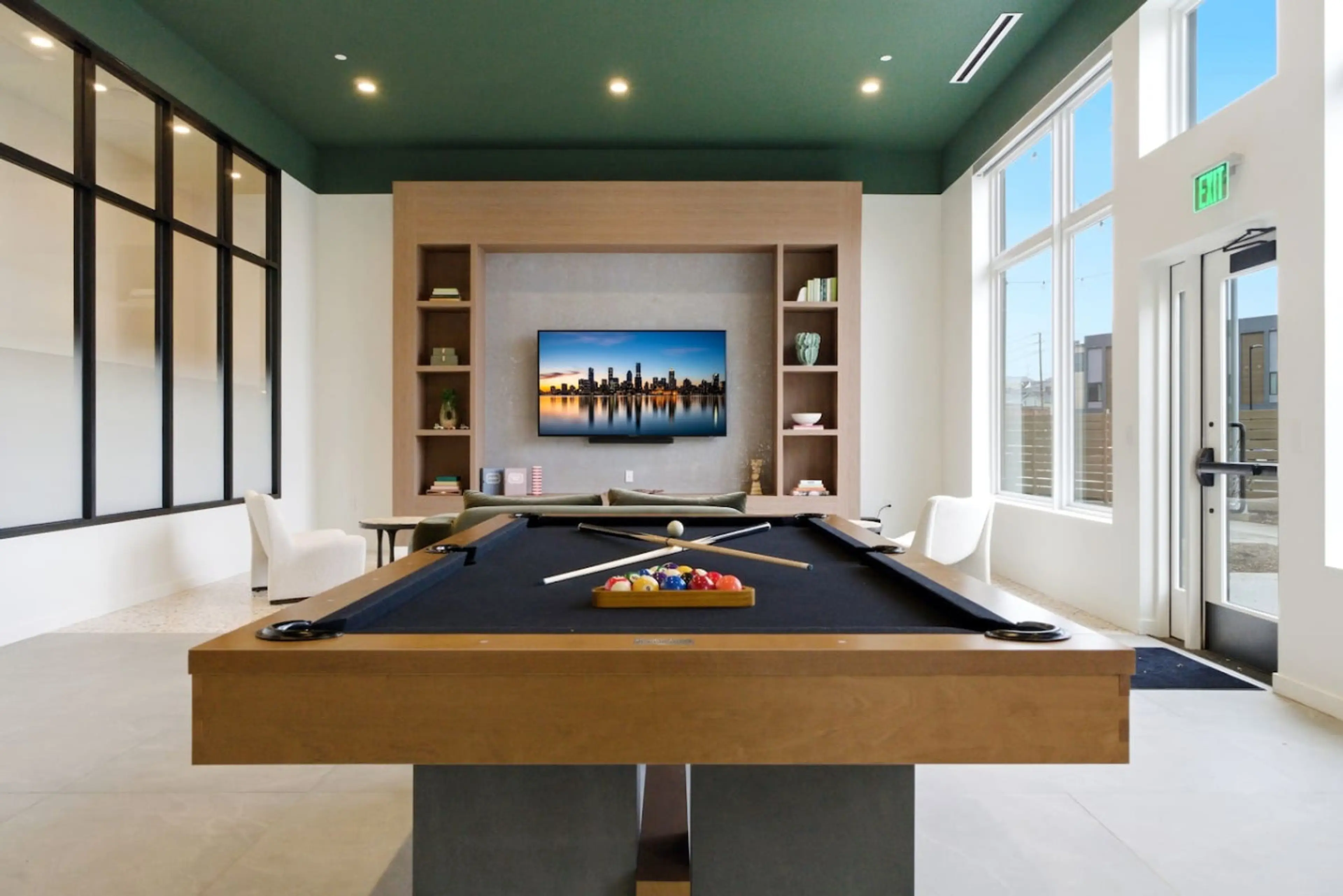 Games room with a billiards table, seating and a screen in a Nearwell building