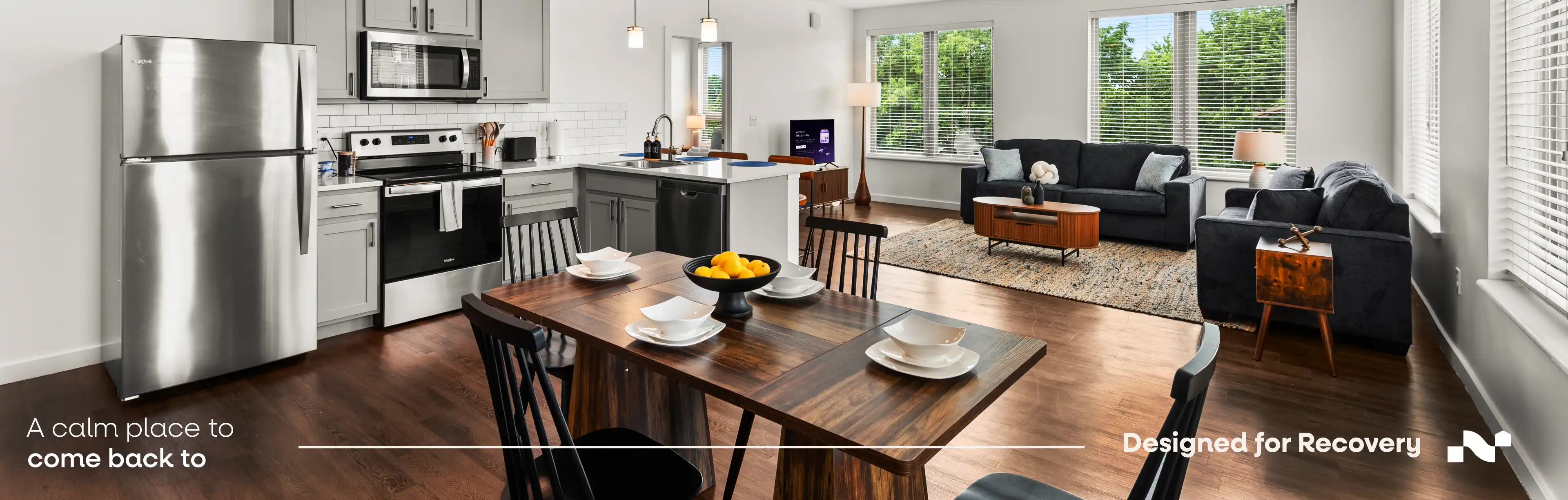 Couple sharing coffee at the kitchen island of a furnished Nearwell apartment near University Hospitals in Cleveland at sunset.