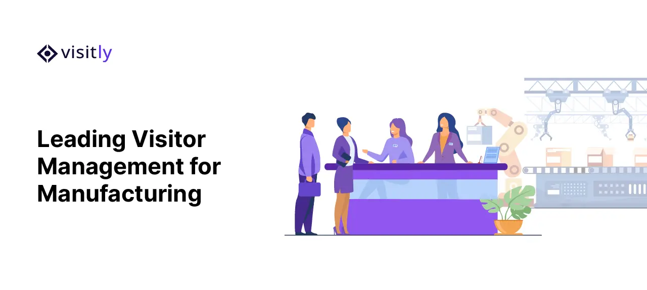 Receptionists greeting two visitors at a desk in front of a factory production line
